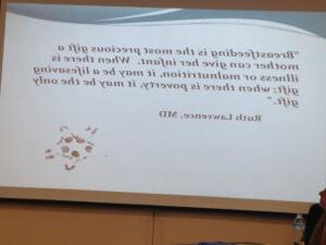 A quote from Dr. Lawrence displayed on a monitor during a presentation.